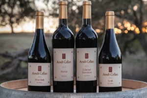 Arndt Cellars wine bottles of Petite Sirah, Merlot, Cabernet Sauvignon, and Syrah
